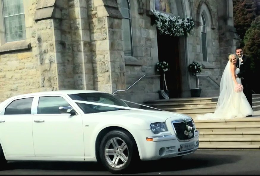 Glamorous Dressed Bride and Groom leaving Church into Beautiful white Bentley Rental Glamorous Dressed Bride and Groom leaving Church into Beautiful white Bentley Rental
